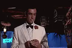 James Bond checks his watch