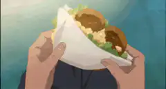 Boy holding takoyaki looking surprised
