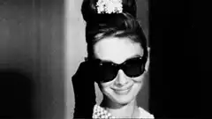 Audrey Hepburn removes sunglasses