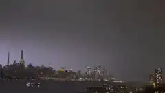 Lightning storm over city skyline