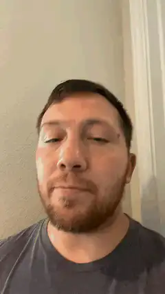 Man blinking and looking at camera