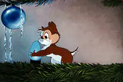 Chipmunk hugging a frozen Christmas ornament