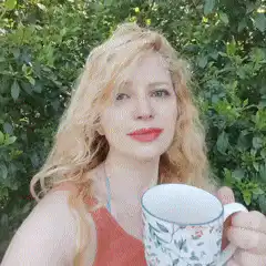 woman holding floral mug outdoors