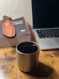Coffee cup on desk with laptop