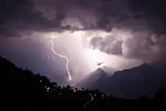 Lightning strike over mountain village