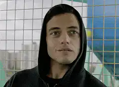 Rami Malek smirking and smiling