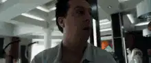 Man puts on glasses and looks surprised