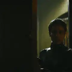 Batman and Catwoman in a dark room