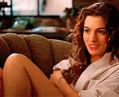 Hathaway smiling on the couch