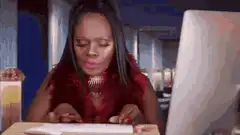 Woman typing on keyboard with surprised expression