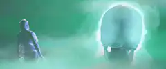 Hooded figure beams at giant skull