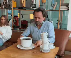 Man drinks giant coffee cup