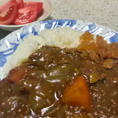 plate of japanese curry rice with tomatoes