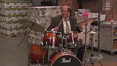 Man playing drums in a warehouse