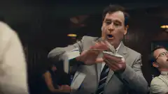 Man throwing paper airplane in office
