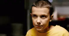 Eleven smirks in yellow shirt