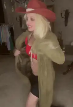Woman in red hat and coat flips the bird