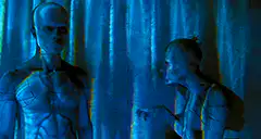 Two aliens talking in blue light