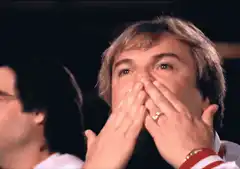 Man covers mouth in shock