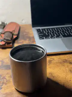 metal cup on wooden desk