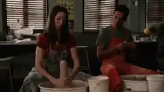 Girl and boy at pottery wheels