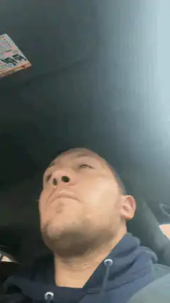 Man in car looking up