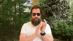 Bearded man clapping in sunglasses