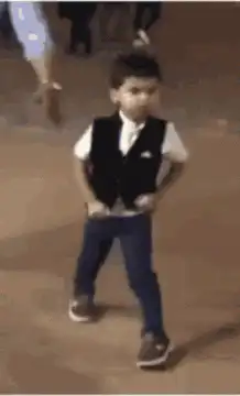 Little boy takes off vest and dances