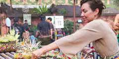 woman making offerings at temple