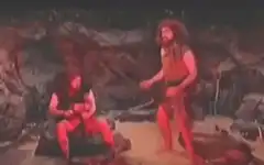 Two cavemen in a cave