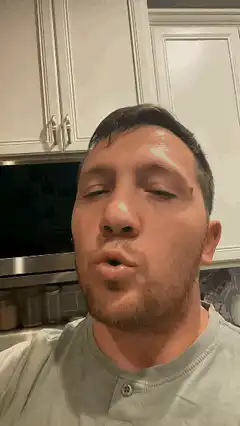 Man making funny faces in kitchen