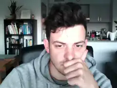 man in grey hoodie covering mouth