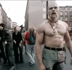 Shirtless man pointing finger up