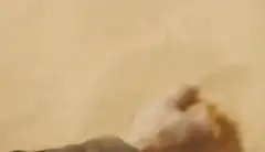 Hand catching falling sand