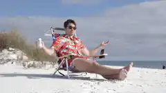 Man in Hawaiian shirt on beach