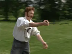Terry Pratchett throwing a dart