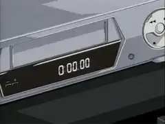 hand inserting vhs tape into player