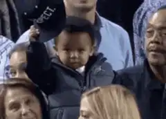 Baby holding up Respect hat