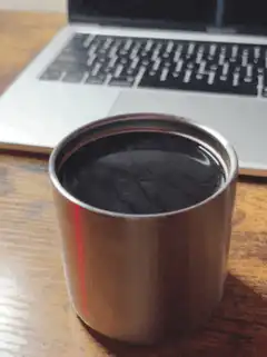 coffee cup on desk with laptop