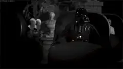 Darth Vader lights lightsaber in black and white