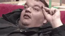 Man plucking eyebrow hair and laughing