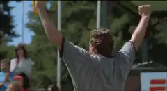 Man raises arms and points excitedly