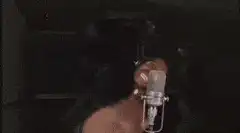 Man singing passionately into a microphone