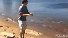 Man throws rock that skips across water