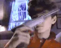 man aiming shotgun at camera