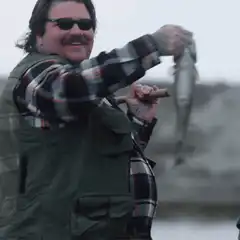 Jesse Pinkman holding a fish and cigar