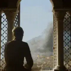 Man walks out onto balcony overlooking burning city