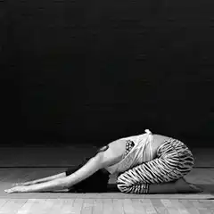 Woman in zebra pants doing child's pose