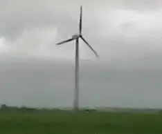 Wind turbine collapses in field