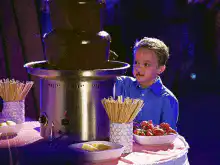 Boy eating chocolate fountain